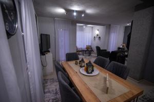 a dining table and chairs in a living room at Villa KIKO Mountain Village in Bitola