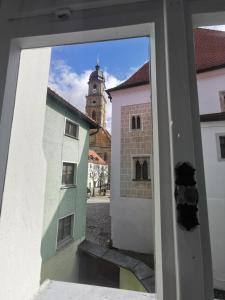a view from a window of a building with a clock tower at Der schönste Platz in der Altstadt in Amberg