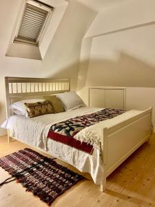 a bedroom with a large bed with a rug at Pluto House in Kent