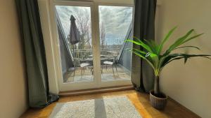 een deur met een plant in een kamer met een balkon bij ApartmentOase #2 in Merseburg