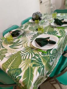 a table with a green and white patterned table cloth at ALOJAMIENTOS EN CATARATAS Depto 1 in Puerto Iguazú