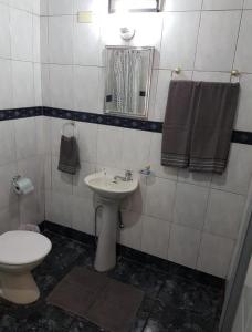 a bathroom with a toilet and a sink at ALOJAMIENTOS EN CATARATAS Depto 1 in Puerto Iguazú