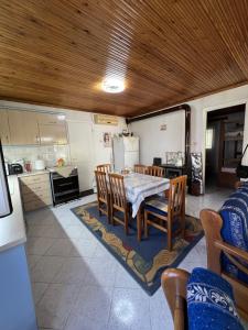 a kitchen and dining room with a table and chairs at Lina's Residence in Stavros