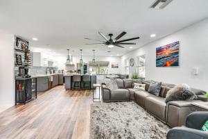 a living room with a couch and a kitchen at Updated Punta Gorda Home about 1 Mi to Laishley Park! in Punta Gorda