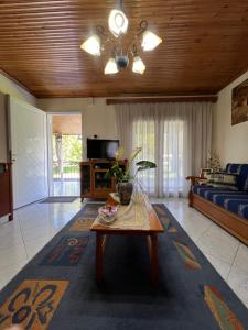 a living room with a couch and a table at Lina's Residence in Stavros