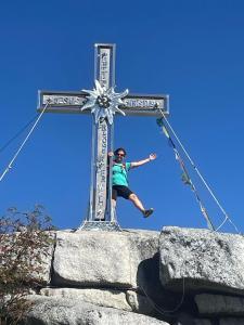 a man on a cross on top of a rock at Berghütte, Chalet - Schwarzenberg am Böhmerwald in Schwarzenberg am Bohmerwald