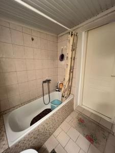 a bathroom with a tub with a toilet in it at Lina's Residence in Stavros +19 photos