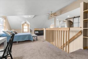 a bedroom with a bed and a staircase in a room at C Street Charm in Coeur d'Alene
