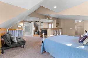 a large bedroom with a bed and a chair at C Street Charm in Coeur d'Alene