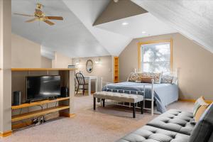 a bedroom with a bed and a flat screen tv at C Street Charm in Coeur d'Alene