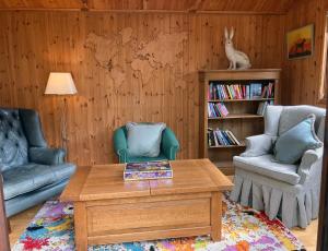 a living room with a couch and a coffee table at The Old Post Office in Broadway