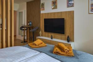 a bedroom with a bed with two towels on it at Alfa Albelli Free Parking Air Condition in Košice