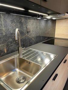 a stainless steel sink in a kitchen at Le Studio in La Louvière