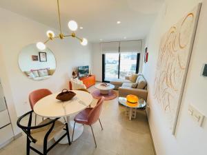 a living room with a table and a couch at La casa de Lola in Motril +17 photos