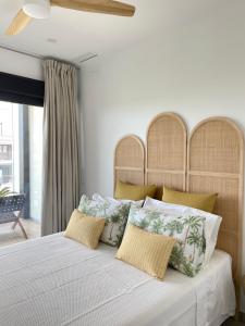 a bedroom with a large white bed with pillows at La casa de Lola in Motril
