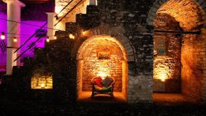 a chair in an archway with candles in it at 1800's in Gjirokastër