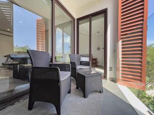 a patio with chairs and a table and a piano at Escape to Tulum, Luxury Apt, Pool & pet friendly in Tulum