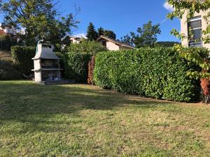 a hedge with a bird house in a yard at Apartment White Zagreb - private parking&garage in Zagreb