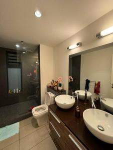 Roches NoiresにあるEntire Luxury Azuri Apartment TBのバスルーム(洗面台2台、トイレ、シャワー付)