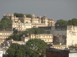a group of white buildings on top of a hill at The Royal Lake View Villa in Udaipur