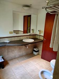 a bathroom with a sink and a mirror at Raices Amambai Lodges in Puerto Iguazú