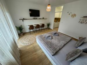 a living room with a bed and a table with chairs at Boho Apartment Birkenstöckl in Bad Reichenhall +12 photos