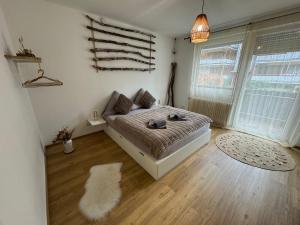 a bedroom with a bed and a white rug at Boho Apartment Birkenstöckl in Bad Reichenhall