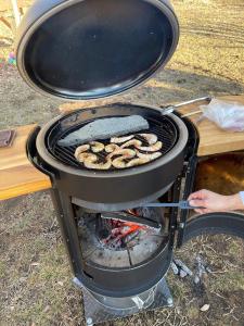 a grill with a bunch of food cooking on it at Camp inn Kiyosato GRANDEUR - Vacation STAY 42081v in Hokuto