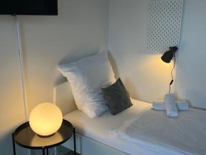 a bed with two pillows and a lamp on it at Schlafkonzept Hannover in Hannover