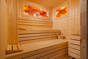 a wooden sauna with a wooden tub in a room at Prestige Apartments 12 in Wrocław