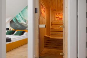 a small room with a bed in a wooden cabin at Prestige Apartments 12 in Wrocław