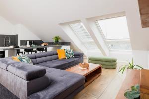 a living room with a couch and a table at Prestige Apartments 12 in Wrocław