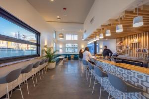 a restaurant with a bar with people sitting at it at The Imperial in Albuquerque