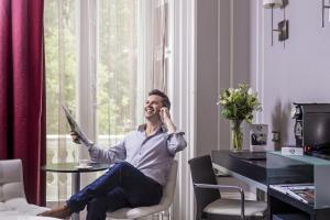 a man sitting in a chair in a room at The Queens Gate Hotel in London