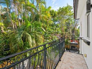 a balcony with a black fence and palm trees at Walk to Las Olas Heated Splash Pool Jacuzzi in Fort Lauderdale