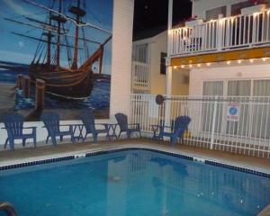 a swimming pool with chairs and a boat on the side of a building at 23 B ST APARTMENTS in Hampton