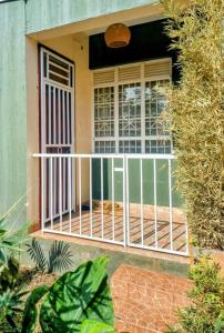 a front door of a house with a gate at Lovely Double Bed with a Private Garden Nook in Kira