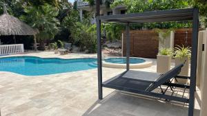 een stoel naast een zwembad bij PUUR! appartementen Curaçao in Jan Thiel