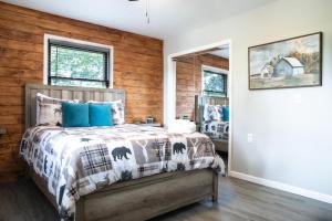 a bedroom with a bed with blue pillows at Modern Mountain - Welcoming House in Tennessee in Sevierville