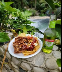 a plate of food and a bottle of soda at Villa in Santa Cruz de Barahona