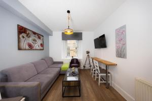 a living room with a couch and a table at Warm&Welcoming City Centre Apartments by Meadows 6 in Edinburgh