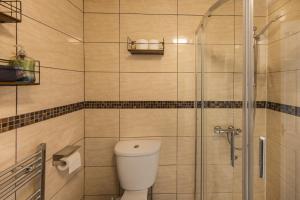 a bathroom with a toilet and a glass shower at Warm&Welcoming City Centre Apartments by Meadows 6 in Edinburgh