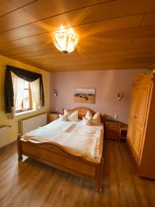 Landpension und Reiterhof Peter Fiala في Utzberg: غرفة نوم بسرير كبير بسقف خشبي
