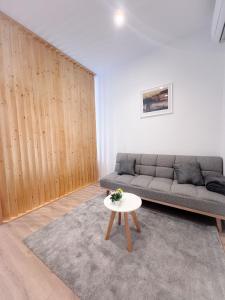 ein Wohnzimmer mit einem Sofa und einem Tisch in der Unterkunft Apartman No. 2 in Zagreb