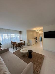 a living room with a couch and a table at Green Island Inn in Fort Lauderdale