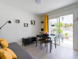 a living room with a couch and a table at Armonia Pool View & Wi-Fi by iRent Fuerteventura in Corralejo