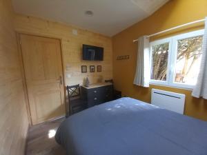 a bedroom with a bed and a window and a door at Le Clos du Jardinier in Châtillon-sur-Seine +10 photos