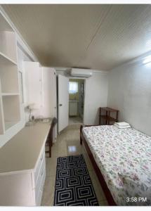 a small room with a bed and a kitchen at Thrillers for the guest that works remote in True Blue