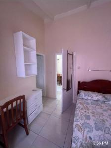 a bedroom with a bed and a dresser and a door at Thrillers for the guest that works remote in True Blue