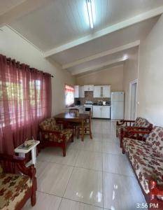 a living room with a table and chairs and a kitchen at Thrillers for the guest that works remote in True Blue